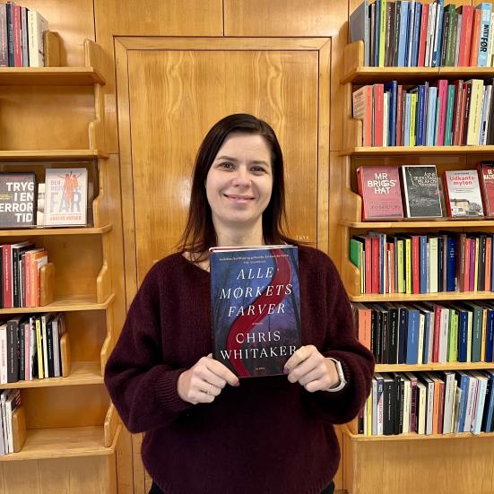 Bibliotekar Marianne Wismar Mühring med bogen "Alle mørkets farver"