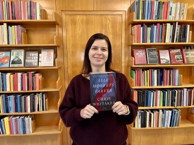 Bibliotekar Marianne Wismar Mühring med bogen "Alle mørkets farver"