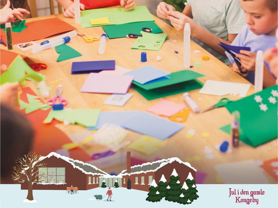 Børn sidder omkring bord og laver kreativt pynt. I bunden en illustration af et sneklædt Nyborg Bibliotek samt ordene "Jul i den gamle kongeby"